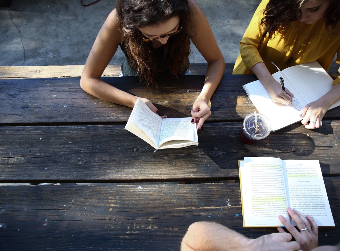 Students studying at a picnic table